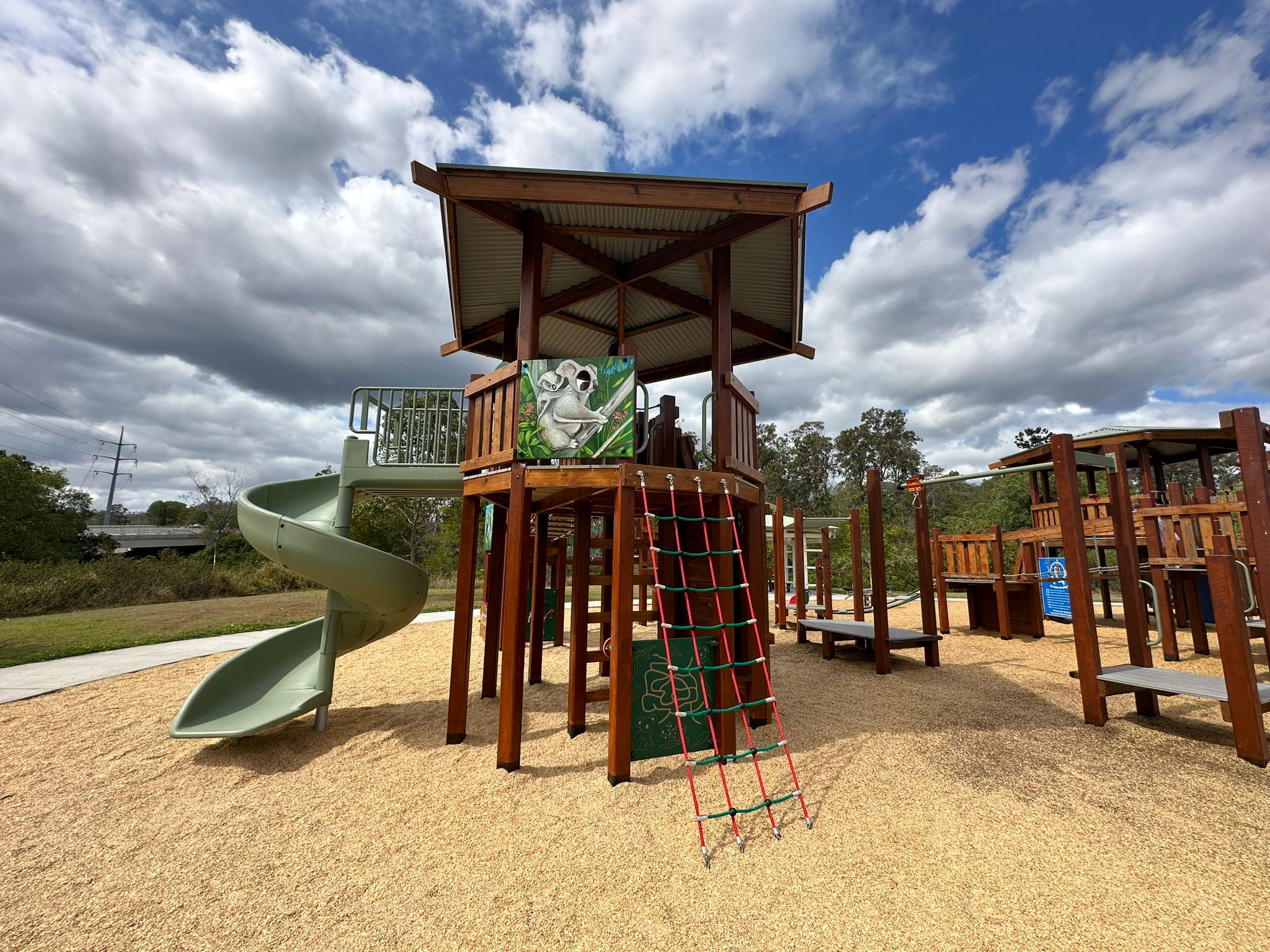 Honeyeater Park Playground featuring Tower, slide, and climbing features.